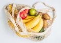 Eco cotton string mesh bag with fruits. Bananas, apples, kiwi, lime and avocado. Ecological Zero Waste Food Shopping