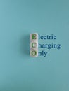 ECO electric charging only symbol. Concept green words ECO electric charging only on wooden cubes