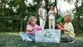 Eco family. Small brother and sister throwing used plastic bottles into recycle bin while collecting plastic waste in Royalty Free Stock Photo