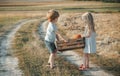 Eco farm for kids. Childhood memories. Eco resort child activities. Happy children farmers working with spud on field Royalty Free Stock Photo
