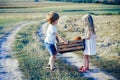 Eco farm for kids. Childhood memories. Eco resort child activities. Happy children farmers working with spud on field Royalty Free Stock Photo