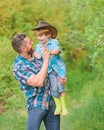 Eco farm. small boy child help father in farming. father and son in cowboy hat on ranch. kid in rubber boots. happy man Royalty Free Stock Photo