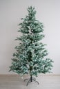 Eco-friendly artificial tree for the new year. A bare Christmas tree without decorations is standing against a white Royalty Free Stock Photo