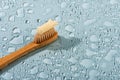 Eco-friendly bamboo toothbrush on the blue wet background Royalty Free Stock Photo