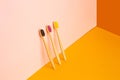 Eco-friendly bamboo toothbrushes on fashion color background