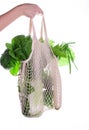 Eco-friendly beige shopping bag with grapes on a white background. String bag with fruits. Zero waste, no plastic concept