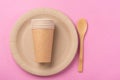 Eco-friendly biodegradable dishes on a pink background