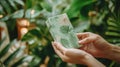 Eco-Friendly Biodegradable Packaging Held in Hands Surrounded by Plants Royalty Free Stock Photo