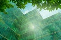 Eco-friendly building in the modern city. Sustainable glass office building with tree for reducing heat and carbon dioxide. Office