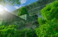 Eco-friendly building with vertical garden in modern city. Green tree forest on sustainable glass building. Energy-saving Royalty Free Stock Photo