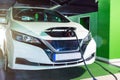 Eco friendly car. Hybrid vehicle - green technology of future. Electric car charge battery on eco energy charger station Royalty Free Stock Photo