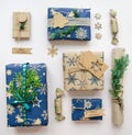 Eco friendly Christmas composition with gift boxes in craft reusable paper and natural decor on white background top view. Zero Royalty Free Stock Photo