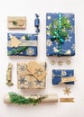 Eco friendly Christmas composition with gift boxes in craft reusable paper and natural decor on white background top view. Zero Royalty Free Stock Photo