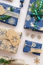 Eco friendly Christmas composition with gift boxes in craft reusable paper and natural decor on white background top view. Zero Royalty Free Stock Photo