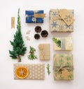 Eco friendly Christmas composition with gift boxes in craft reusable paper and natural decor on white background top view. Zero Royalty Free Stock Photo