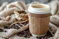 Eco friendly compostable coffee cup featuring kraft sleeve and coffee beans in front view Royalty Free Stock Photo