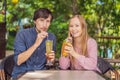 Eco friendly couple using reusable stainless steel straw to drink fruit tea