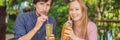 Eco friendly couple using reusable stainless steel straw to drink fruit tea BANNER, LONG FORMAT