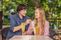 Eco friendly couple using reusable stainless steel straw to drink fruit tea