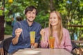 Eco friendly couple using reusable stainless steel straw to drink fruit tea