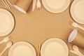 Eco friendly, plastic free disposable dishware for takeout. Frame on a brown paper background. Royalty Free Stock Photo