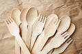 eco friendly disposable kitchenware utensils on paper background. look from above. wooden forks and spoons. eco friendly