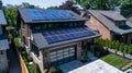 Eco Friendly Environment: Urban house with sunlit roof installing solar photovoltaic panels on rooftop, renewable energy source Royalty Free Stock Photo