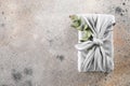 Eco-friendly fabric reusable gift packaging with eucalyptus. Sustainable gift wrapping. Flat lay