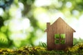 Eco friendly home. House model on green grass, space for text Royalty Free Stock Photo