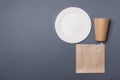 Eco-friendly kitchen ware, plate, cup, bag, in gray colored paper background with copy space. top view. close-up Royalty Free Stock Photo