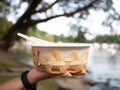 eco friendly Organic bagasse bowl for single used in hand on blur background