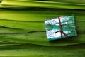 Eco friendly pack with gift wrapped in used paper and green leaves to combat the planet pollution in the world