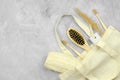 Eco-friendly personal care products in a linen bag. Bamboo toothbrushes, wooden comb, pumice stone and loofah washcloth Royalty Free Stock Photo