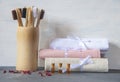 Eco-friendly personal hygiene items made of natural materials. Toothbrushes, linen towels, and bottles of rose oil Royalty Free Stock Photo