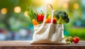 Eco friendly reusable shopping bag filled with vegetables on a blur background