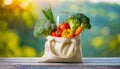 Eco friendly reusable shopping bag filled with vegetables on a blur background