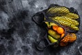 Eco friendly reusable shopping string bag, filled with fruits. Eco friendly, plastic free. Black background. Top view. Copy space Royalty Free Stock Photo