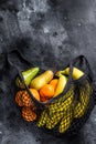 Eco friendly reusable shopping string bag, filled with fruits. Eco friendly, plastic free. Black background. Top view. Copy space Royalty Free Stock Photo