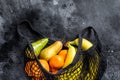 Eco friendly reusable shopping string bag, filled with fruits. Eco friendly, plastic free. Black background. Top view. Copy space Royalty Free Stock Photo