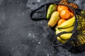 Eco friendly reusable shopping string bag, filled with fruits. Eco friendly, plastic free. Black background. Top view. Copy space Royalty Free Stock Photo