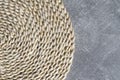 Eco-friendly round natural corn straw placemat table mat on a concrete look coffee table Royalty Free Stock Photo