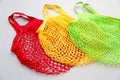 Eco-friendly shopper bags in red, yellow, green colors. Alternative shopping