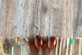 Eco-friendly spoons, forks, bamboo straws, toothbrushes, hair comb, glass container, and reusable bag on wooden table Royalty Free Stock Photo