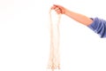 Eco friendly string bag in the hand on white background, responsible consumption. Ecological concept