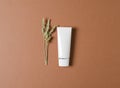 Eco-friendly tube with cream on a brown background. Cosmetics for women with a natural composition. Feminine hygiene product for
