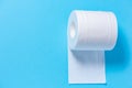 Eco-friendly white toilet paper on a blue background close-up