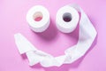 Eco-friendly white toilet paper on a pink background close-up