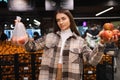 Eco friendly woman buys apples in the supermarket. Female grocery shopper opposes the use of plastic bags. Royalty Free Stock Photo