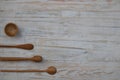 Eco-friendly wooden bowl, spoons and honey stick on wooden table background. Environmentally friendly kitchen utensil flat lay Royalty Free Stock Photo