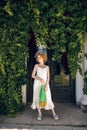 Young woman in a white long dress holding a green mesh bag in her hands Royalty Free Stock Photo